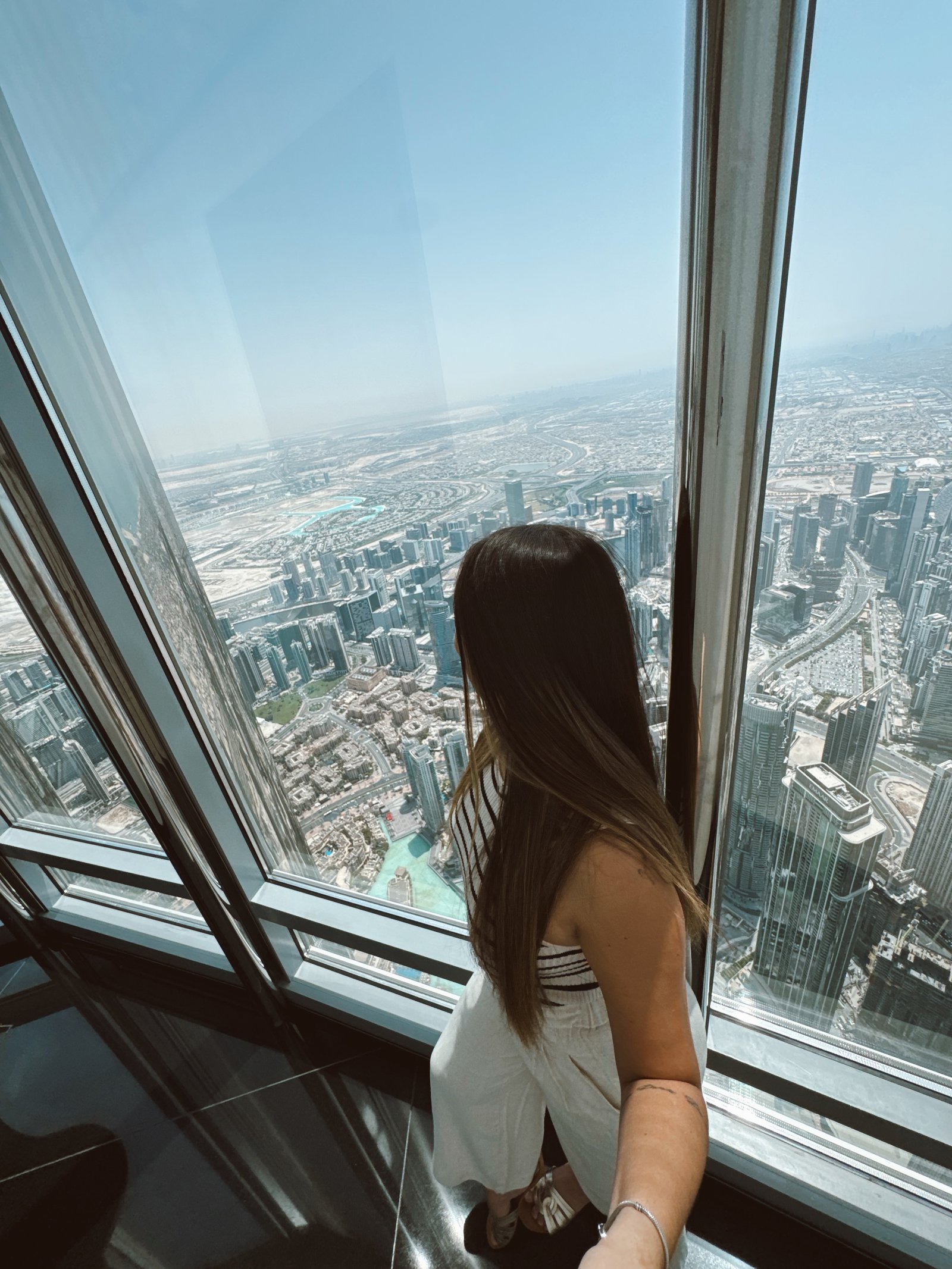 Denise observando Dubai do alto do Burj Khalifa
